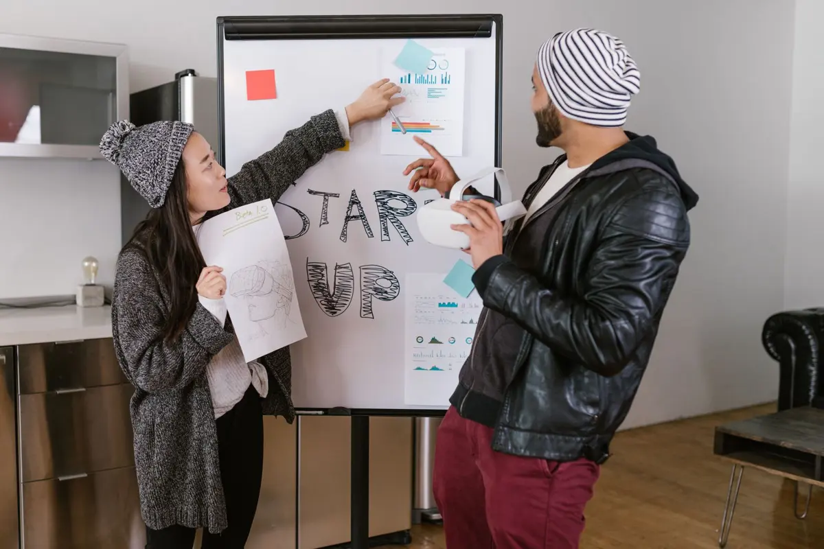 A founder working through a plan on a whiteboard