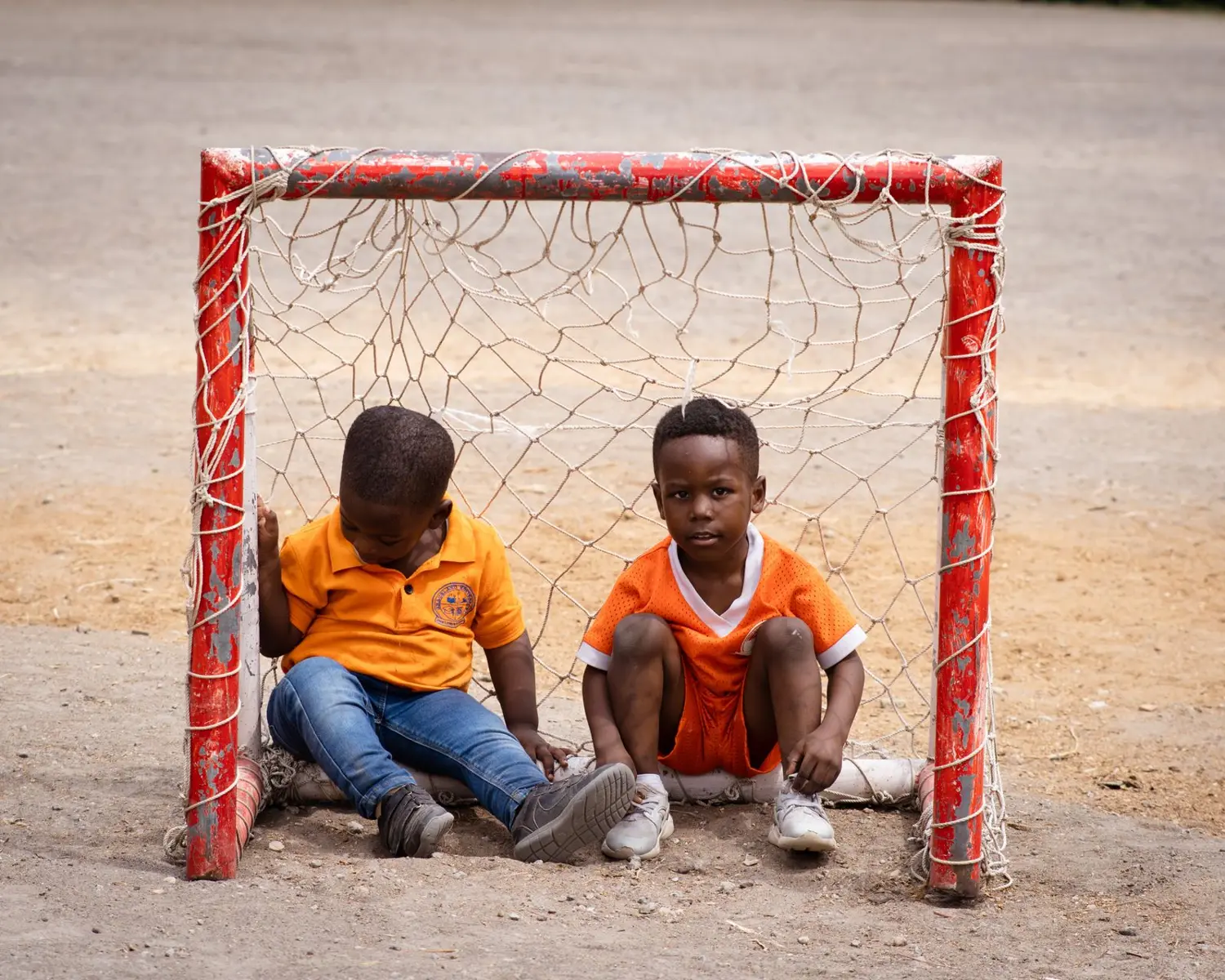 Two boys in a football goal